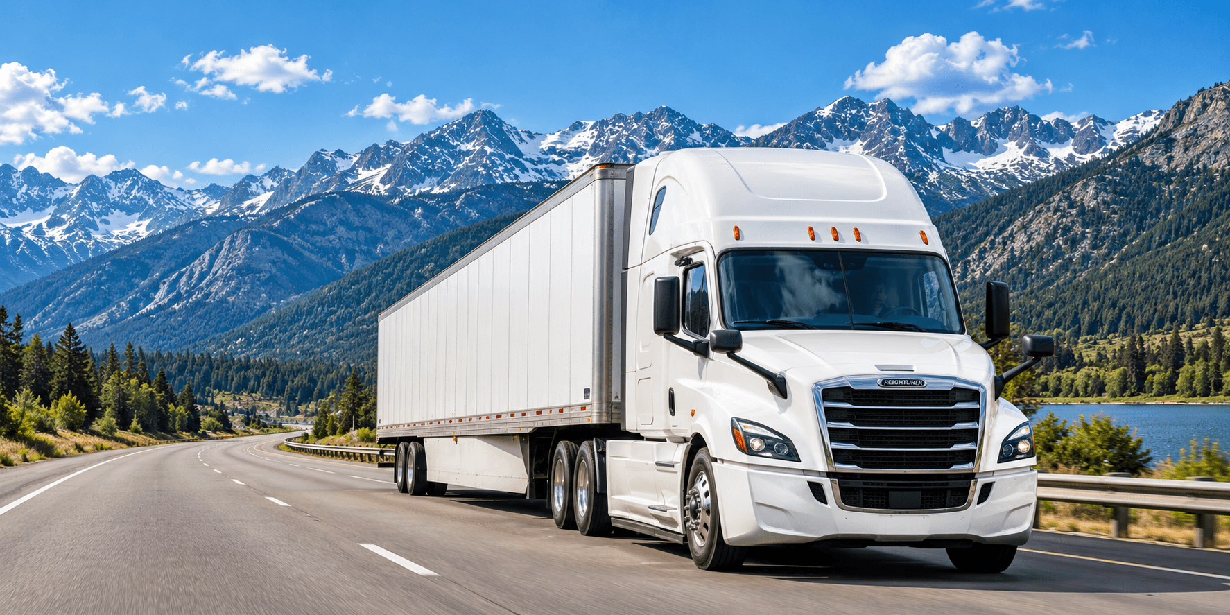 White semi-truck pulling a white dry van trailer on a mountain highway